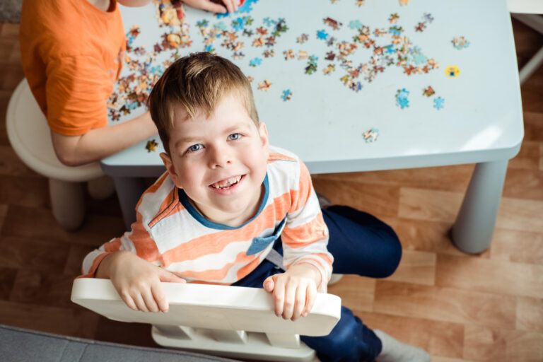 Image of a little boy working on a puzze